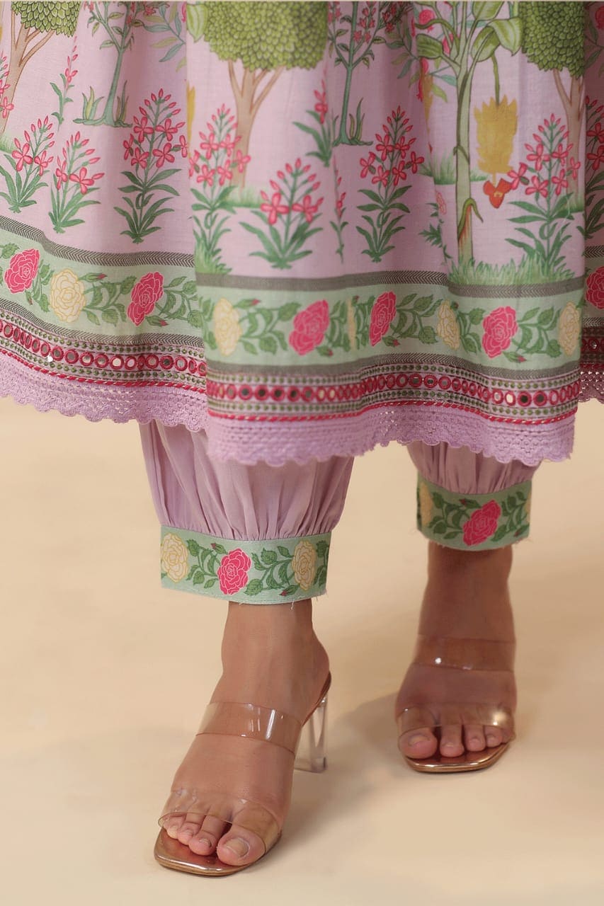 Beautiful Pink Muslin Alia Suit Set which is beautifully decorated with intricate hand embroidery, Zari weaving and digital prints. It is paired with matching pants and lace dupatta.