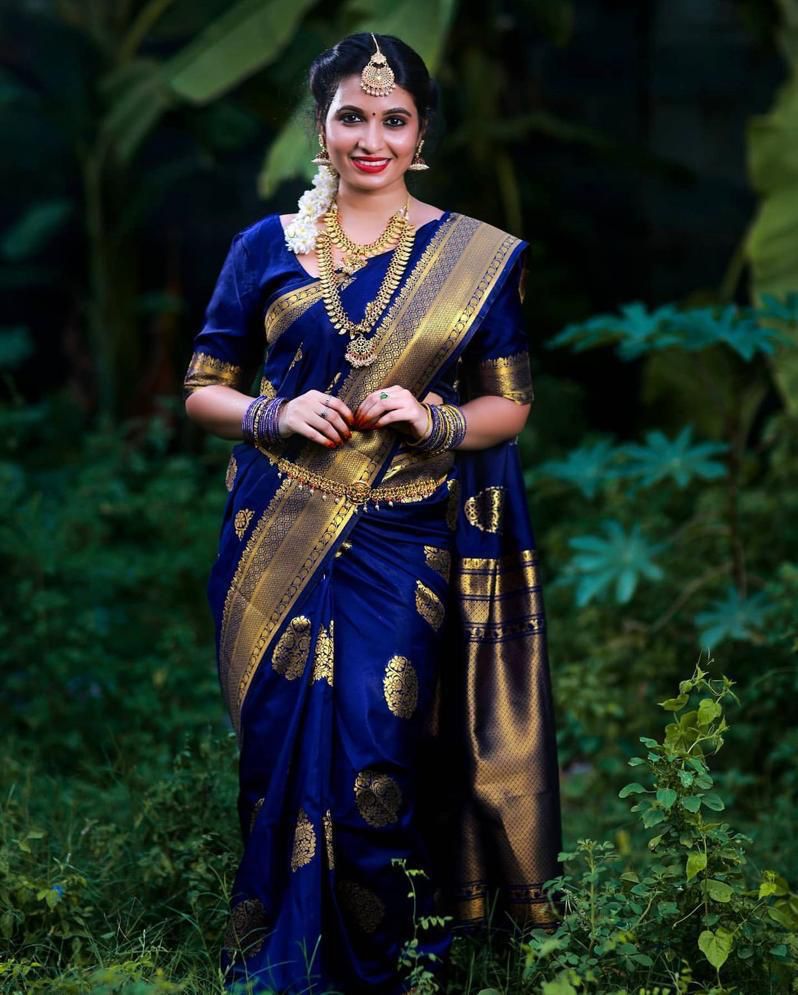 Photo of blue ink pattu sari with orange elbow length blouse and gold  jewellery